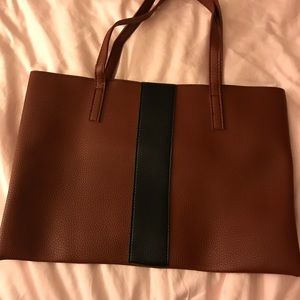 Brown purse with black stripe down the center